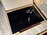 a broken stove top in a box on the floor