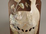 a picture of a decorative bottle with a bird on it