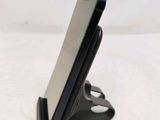 a cell phone that is on a stand on a table