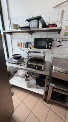 a kitchen with a stove, microwave, and other appliances in it