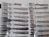 a lot of forks and spoons that are on a table