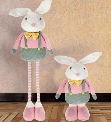 two stuffed animals are standing next to each other on a wooden floor