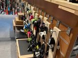 a lot of skis and snowboards on display in the store
