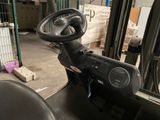 a close up of a forklift driver ' s steering in a warehouse