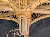 a wicker umbrella that is hanging on the wall
