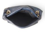the inside of a blue leather purse with a gold clasp