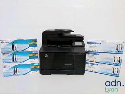 a printer sitting on top of a table next to a box of tissues