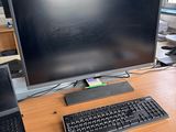 a desk with a laptop, monitor, keyboard and mouse on it