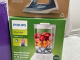 packaging of a blender sitting on a table next to a box of fruit