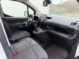 the interior of a white van with black seats and a steering wheel