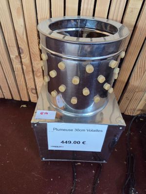 a metal trash can sitting on top of a wooden floor
