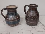 two vases that are sitting on a table