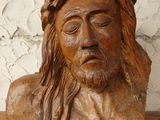 statue of jesus with crown of thorns on head on wooden table
