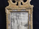 an image of a mirror with a gold frame on a black background