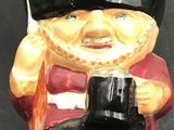 a ceramic figurine of a soldier with binoculars