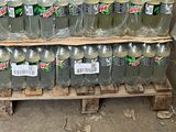 bottles of mountain dew are stacked on a pallet in a warehouse