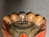 a wooden mask on display on a table