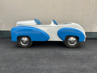 a blue and white toy car parked in a parking lot