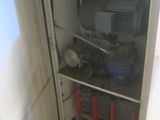 a small cabinet with tools in it in a room