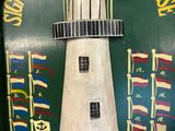 a picture of a picture of a lighthouse on the wall