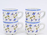 three coffee cups with blue flowers on them sitting on a white surface
