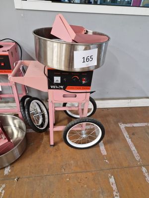 une machine posée par terre à côté d'un bol