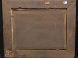 an old wooden picture frame with a small hole in the middle