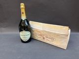 an image of a bottle of champagne next to a wooden box