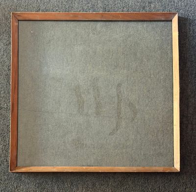 an old picture frame with a small drawing of a cat on it