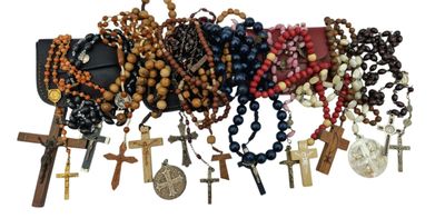 many different types of rosary hanging on the wall