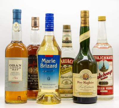 several bottles of alcohol are lined up on a white surface