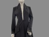 an image of a mannequin dressed in a black coat and black pants
