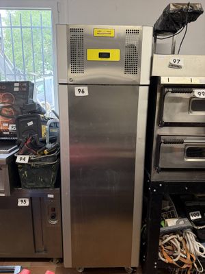 a silver refrigerator and some other appliances in a room