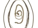 a lot of different types of necklaces on a white surface