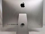 a silver apple computer sitting on top of a white table