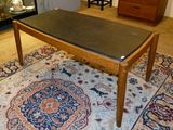 a table with a black top on a rug in a living room