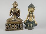 pair of bronze statues of a seated person and a seated person