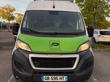 a green and white van parked in a parking lot