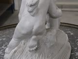 a statue of a boy and a girl sitting on a table