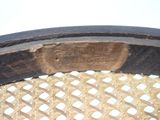 a close up of a wooden chair with a hole in it