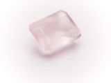 a pink quartz stone on a white background