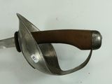 a close up of a metal object with a brown handle