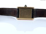 a watch that is sitting on top of a white surface