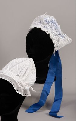 pair of white bonnets with blue ribbon and lace