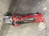 a red drill that is laying on the ground