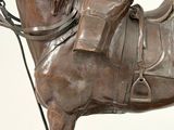 a statue of a horse with a saddle on it ' s back