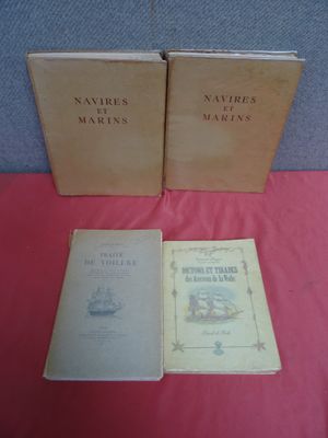 Trois livres sont posés sur une table recouverte d'une nappe rouge.