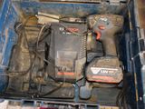 a tool box with a drill and a battery in it
