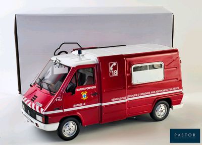 a red toy ambulance truck with a box in the background