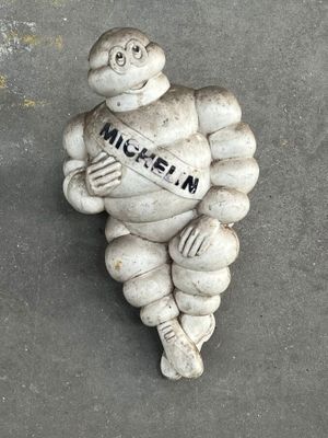 a statue of a man holding a sign that says michel